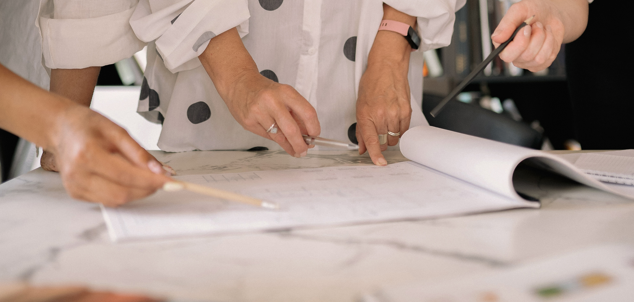 A persons hands as they review plans